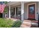Inviting front porch with seating and a red door that reads 'hello.' at 309 Edinburgh St, Summerville, SC 29483