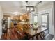 Bright kitchen with stainless appliances, wooden cabinets, hardwood floor, and a dining table near the door at 309 Edinburgh St, Summerville, SC 29483
