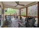 Relaxing screened-in porch featuring comfortable rocking chairs and ceiling fan, perfect for enjoying the outdoors at 309 Edinburgh St, Summerville, SC 29483