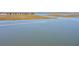 Expansive aerial shot of a scenic waterfront with a passing boat and residential area in the background at 410 E Indian Ave, Folly Beach, SC 29439
