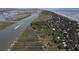 Scenic aerial view of a coastal community with private docks, marsh, and beach access at 410 E Indian Ave, Folly Beach, SC 29439
