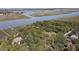 Stunning aerial view of waterfront homes surrounded by lush greenery, showcasing the serene coastal setting at 410 E Indian Ave, Folly Beach, SC 29439
