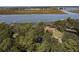 Home nestled within an expansive wooded lot with waterfront views at 410 E Indian Ave, Folly Beach, SC 29439