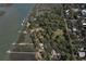 Aerial view of a waterfront community with docks and water access amid mature trees at 410 E Indian Ave, Folly Beach, SC 29439