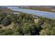 Spacious lot features a cottage style home with lush trees at 410 E Indian Ave, Folly Beach, SC 29439
