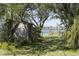 Charming shed and grassy path lead to a private pier with water views, ideal for waterfront living at 410 E Indian Ave, Folly Beach, SC 29439