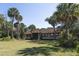 Charming single story home with mature trees and a screened in porch at 410 E Indian Ave, Folly Beach, SC 29439
