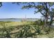 Grassy lot with waterfront views and a dock at 410 E Indian Ave, Folly Beach, SC 29439