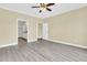 Bright bedroom with a ceiling fan and gray vinyl plank flooring at 418 Eastern Isle Ave, Summerville, SC 29486
