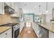 Open kitchen featuring a large island, stainless steel appliances, and a view into the dining area at 418 Eastern Isle Ave, Summerville, SC 29486
