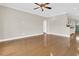 Open-concept living room with hardwood floors, fan, and a view of the kitchen at 418 Eastern Isle Ave, Summerville, SC 29486