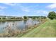Scenic pond view with a fountain and surrounding landscaping in a residential community at 418 Eastern Isle Ave, Summerville, SC 29486