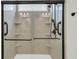 Modern shower with glass door, built in shelves, and bronze fixtures at 418 Eastern Isle Ave, Summerville, SC 29486