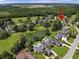 Expansive aerial view showcasing beautiful homes, lush greenery, and a serene pond in a community at 4218 Club Course Dr, North Charleston, SC 29420