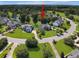 Beautiful aerial view of a home nestled in a lush, green neighborhood near a small lake at 4218 Club Course Dr, North Charleston, SC 29420