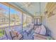 Relaxing screened-in porch with comfortable seating, ceiling fans, and views of the landscaped backyard at 4218 Club Course Dr, North Charleston, SC 29420