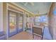 Inviting screened porch with comfortable seating, ceiling fan, and views of the picturesque backyard at 4218 Club Course Dr, North Charleston, SC 29420