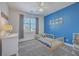 This bedroom offers a blue accent wall, day bed and neutral carpet at 4218 Club Course Dr, North Charleston, SC 29420