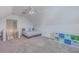Bright attic bedroom featuring a ceiling fan, neutral paint and carpet, and bonus storage shelves at 4218 Club Course Dr, North Charleston, SC 29420