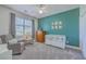 Cute Bedroom with green accent wall, crib, comfortable seating and natural light at 4218 Club Course Dr, North Charleston, SC 29420