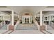 Inviting entrance to the Coosaw Creek Clubhouse with decorative wreaths and benches at 4218 Club Course Dr, North Charleston, SC 29420