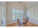 Cozy dining area with natural light, modern lighting fixture, and views of the landscaped yard at 4218 Club Course Dr, North Charleston, SC 29420