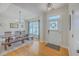 Bright dining room featuring a farmhouse table, bench seating, hardwood floors, and natural light at 4218 Club Course Dr, North Charleston, SC 29420