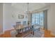 Elegant dining room featuring a farmhouse-style table, decorative lighting, and wainscoting at 4218 Club Course Dr, North Charleston, SC 29420