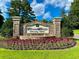 Beautiful community entrance sign amidst vibrant flowers and greenery, inviting you home at 4218 Club Course Dr, North Charleston, SC 29420