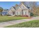 Well-maintained two-story home with lush lawn, a paved driveway, and inviting covered front porch at 4218 Club Course Dr, North Charleston, SC 29420