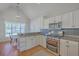 Bright kitchen featuring stainless appliances, granite countertops, and ample white cabinets at 4218 Club Course Dr, North Charleston, SC 29420