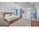 Spacious main bedroom featuring a large bed, tray ceiling, and access to a private balcony at 4218 Club Course Dr, North Charleston, SC 29420