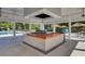 Outdoor grill area, featuring a large grill station, spacious counter, ceiling fans, and poolside access at 4218 Club Course Dr, North Charleston, SC 29420