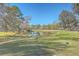 Scenic view of a well-maintained pond and golf course, creating a serene and picturesque setting at 4218 Club Course Dr, North Charleston, SC 29420
