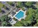 Aerial view of a large, modern pool with a sunbathing area and shaded gazebos surrounded by lush greenery at 4218 Club Course Dr, North Charleston, SC 29420
