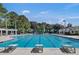 Community pool with diving blocks and lounge seating surrounded by lush, mature trees and plenty of space to relax at 4218 Club Course Dr, North Charleston, SC 29420