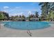 Community pool featuring covered seating areas, ladders, lounge seating, and mature trees for a relaxed environment at 4218 Club Course Dr, North Charleston, SC 29420