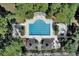 Aerial view of large swimming pool with a sunbathing area, lounge chairs, and shaded gazebos surrounded by mature trees at 4218 Club Course Dr, North Charleston, SC 29420