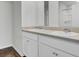 Bright bathroom featuring double sinks, white cabinets, and a large mirror at 446 White Scallop Way, Summerville, SC 29486