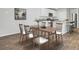 Cozy dining area adjacent to a modern kitchen, featuring hardwood floors and ample seating for six at 446 White Scallop Way, Summerville, SC 29486