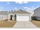 Charming single-story home featuring a two-car garage and manicured front lawn on a sunny day at 446 White Scallop Way, Summerville, SC 29486