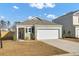The exterior of this home has a two car garage, a paved driveway, and manicured bushes at 446 White Scallop Way, Summerville, SC 29486