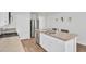 Bright kitchen featuring an island with stainless steel appliances and hardwood style floors at 446 White Scallop Way, Summerville, SC 29486