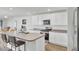 Modern kitchen with white cabinetry, stainless steel appliances, and an island with seating at 446 White Scallop Way, Summerville, SC 29486