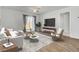 Inviting living room with neutral tones, hardwood floors, contemporary furniture, and natural light at 446 White Scallop Way, Summerville, SC 29486