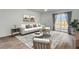 Cozy living room featuring a white sofa, stylish rug, and a sliding glass door at 446 White Scallop Way, Summerville, SC 29486