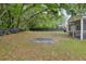 Large backyard with a screened-in porch, mature trees, and ample space for outdoor activities at 5024 Blair Rd, Summerville, SC 29483