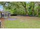 View of home's backyard with patio, lawn, and wooded area at 5024 Blair Rd, Summerville, SC 29483