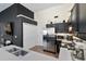 Modern kitchen boasts stainless steel appliances, ample counter space, and dark cabinets at 5024 Blair Rd, Summerville, SC 29483