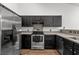 A well-equipped kitchen showcases stainless steel appliances and contrasting dark cabinetry at 5024 Blair Rd, Summerville, SC 29483